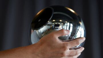 FILE PHOTO: Hands hold the biometric imaging device, the Orb, of the identity and financial public utility Worldcoin, which aims to create a World ID digital passport, with a tradeable cryptocurrency, in Berlin, Germany August 1, 2023. REUTERS/Annegret Hilse/File Photo