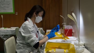 TOKYO, JAPAN - JANUARY 20: A nurse prepares syringes with the Pfizer coronavirus booster vaccination on January 20, 2022 in Tokyo, Japan. Tokyo Metropolitan Government recorded 8,638 new Covid-19 infections today, the highest ever for the city. However, t