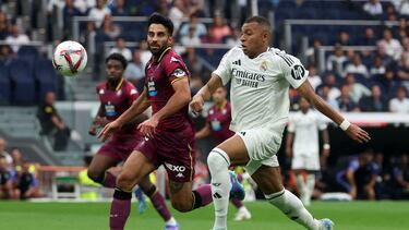 Real Valladolid's Swiss defender #15 Eray Comert and Real Madrid's French forward #09 Kylian Mbappe vie for the ball during the Spanish league football match between Real Madrid CF and Real Valladolid FC at the Santiago Bernabeu stadium in Madrid on August 25, 2024. (Photo by Pierre-Philippe MARCOU / AFP)