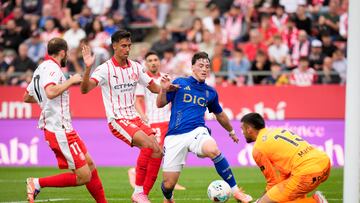 El delantero del Real Oviedo Federico Viñas (c) trata de anotar ante la presencia del portero Paulo Gazzaniga (d) del Girona FC durante el partido de LaLiga disputado en el estadio municipal de Montilivi de Girona