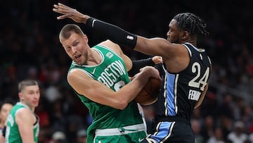 ATLANTA, GEORGIA - MARCH 25: Kristaps Porzingis #8 of the Boston Celtics draws a foul as he drives against Bruno Fernando #24 of the Atlanta Hawks during the first quarter at State Farm Arena on March 25, 2024 in Atlanta, Georgia. NOTE TO USER: User expressly acknowledges and agrees that, by downloading and/or using this photograph, user is consenting to the terms and conditions of the Getty Images License Agreement.   Kevin C. Cox/Getty Images/AFP (Photo by Kevin C. Cox / GETTY IMAGES NORTH AMERICA / Getty Images via AFP)