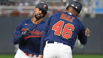 Minnesota Twins outfielder Byron Buxton (25) celebrates his solo home run off of Detroit Tigers starting pitcher Tarik Skubal (29) with third base coach Tony Diaz (46) during the first inning at Target Field.