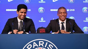 Paris Saint-Germain&#039;s new forward Kylian Mbappe (R) smiles as he sits next to Paris Saint Germain&#039;s Qatari president Nasser Al-Khelaifi during his presentation during a press conference at the Parc des Princes stadium in Paris on September 6, 20