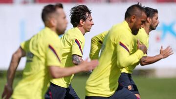 This handout pictured made available by FC Barcelona shows Barcelona's Argentine forward Lionel Messi (C) and teammates attending a training session at the Ciutat Esportiva Joan Gamper in Sant Joan Despi on May 25, 2020. (Photo by Miguel RUIZ / FC BA