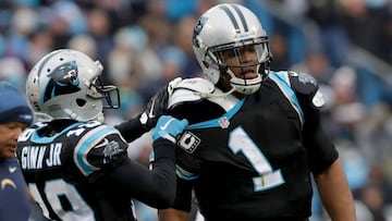 CHARLOTTE, NC - DECEMBER 11: Ted Ginn #19 assists teammate Cam Newton #1 of the Carolina Panthers with his equipment between plays against the San Diego Chargers in the 3rd quarter during their game at Bank of America Stadium on December 11, 2016 in Charlotte, North Carolina. Streeter Lecka/Getty Images/AFP
== FOR NEWSPAPERS, INTERNET, TELCOS & TELEVISION USE ONLY ==