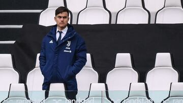 Juventus&#039; Argentine forward Paulo Dybala watches from a tribune during the Italian Serie A football match Juventus Turin vs Benevento on March 21, 2021 at the Juventus stadium in Turin. (Photo by Marco BERTORELLO / AFP)