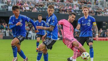 Inter Miami's #5 Sergio Busquets fights for the ball against Montreal's #4 Fernando Alvarez, #25 Gabriele Corbo and #16 Joel Waterman, during the Major League Soccer (MLS) tournament football match between Inter Miami CF and CF Montreal at Chase Stadium in Fort Lauderdale, Florida, on March 10, 2024. (Photo by Chris ARJOON / AFP)