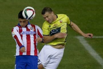 El defensa del L'Hospitalet José Rodríguez (d) lucha un balón con el delantero mexicano del Atlético de Madrid Raúl Jiménez (i) durante el partido de vuelta de los dieciseisavos de final de la Copa del Rey, disputado esta tarde en el estadio Vicente Calderón. 