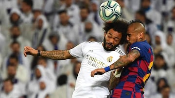Barcelona's Chilean midfielder Arturo Vidal (R) heads the ball with Real Madrid's Brazilian defender Marcelo during the Spanish League football match between Real Madrid and Barcelona at the Santiago Bernabeu stadium in Madrid on March 1, 2020. (Photo by GABRIEL BOUYS / AFP)