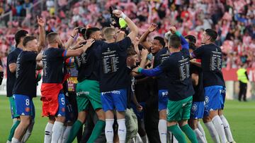 Girona players celebrate their qualification for the UEFA Champions League after winning the Spanish league football match between Girona FC and FC Barcelona at the Montilivi stadium in Girona on May 4, 2024. (Photo by LLUIS GENE / AFP)
