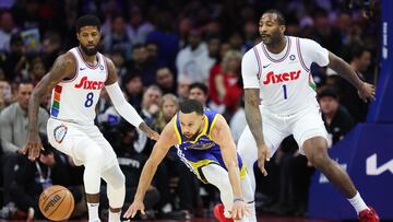 Golden State Warriors guard Stephen Curry (30) looses control of the ball in front of Philadelphia 76ers forward Paul George (8) and center Andre Drummond (1) during the first quarter at Wells Fargo Center.