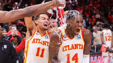 Atlanta Hawks guard Trae Young (11) dumps water on forward AJ Griffin (14) after an overtime victory against the Toronto Raptors at State Farm Arena.