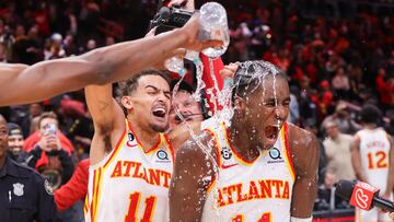 Atlanta Hawks guard Trae Young (11) dumps water on forward AJ Griffin (14) after an overtime victory against the Toronto Raptors at State Farm Arena.