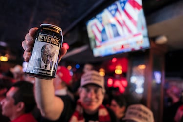 Un partidario del candidato presidencial republicano sostiene una cerveza de edición limitada con una imagen de Trump y las palabras "La venganza de un padre conservador", mientras asiste a la fiesta del New York Young Republican Club durante las elecciones presidenciales estadounidenses de 2024.
