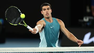 Spain's Carlos Alcaraz hits a return against Serbia's Novak Djokovic during their men's singles quarterfinal match on day ten of the Australian Open tennis tournament in Melbourne on January 22, 2025. (Photo by Martin KEEP / AFP) / -- IMAGE RESTRICTED TO EDITORIAL USE - STRICTLY NO COMMERCIAL USE --