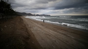 FILE PHOTO: Damage at erosion-affected Maengbang beach is seen as a person fishes in Samcheok, South Korea, November 3, 2021. Picture taken November 3, 2021.   REUTERS/Kim Hong-Ji/File Photo