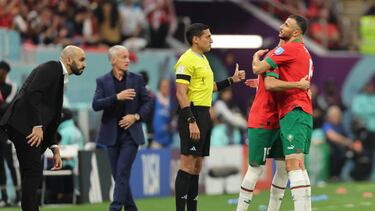 AL KHOR, QATAR - DECEMBER 14: The Fourth Official Jesus Valenzuela Saez reacts whilst Walid Regragui Head coach of Morocco and Didier Deschamps Head coach of France look on as Romain Saiss of Morocco is substituted for Selim Amallah after picking up an injury during the FIFA World Cup Qatar 2022 semi final match between France and Morocco at Al Bayt Stadium on December 14, 2022 in Al Khor, Qatar. (Photo by Youssef Loulidi/Fantasista/Getty Images)
