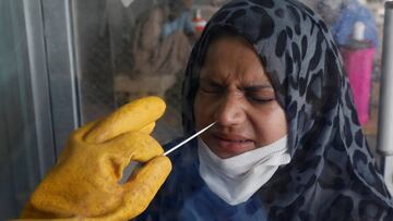A paramedic wearing protective gloves takes a nose-swab sample to be tested for the coronavirus disease (COVID-19), in Karachi, Pakistan July 6, 2020. REUTERS/Akhtar Soomro