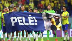 FILE PHOTO: Soccer Football - FIFA World Cup Qatar 2022 - Round of 16 - Brazil v South Korea - Stadium 974, Doha, Qatar - December 5, 2022 Brazil players hold up a banner of former player Pele after the match as Brazil progress to the quarter finals REUTERS/Carl Recine/File Photo