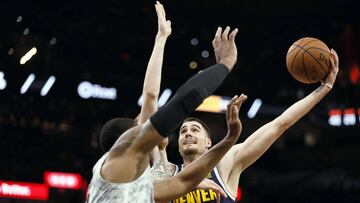 Dec 26, 2018; San Antonio, TX, USA; Denver Nuggets power forward Juan Hernangomez (41) shoots the ball as San Antonio Spurs small forward Davis Bertans (left) and LaMarcus Aldridge (front) defend during the second half at AT&T Center. Mandatory Credit: Soobum Im-USA TODAY Sports