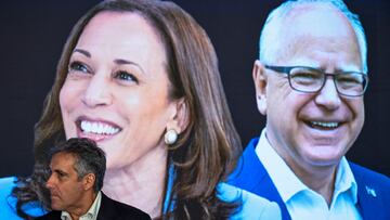 Michael Cohen, former attorney for Republican presidential nominee and former U.S. President Donald Trump, stands in front of a sign with images of Democratic presidential candidate and U.S. Vice President Kamala Harris and U.S. Democratic vice presidential candidate Minnesota Governor Tim Walz ahead of Day 2 of the Democratic National Convention (DNC) at the United Center, in Chicago, Illinois, U.S., August 20, 2024. REUTERS/Vincent Alban