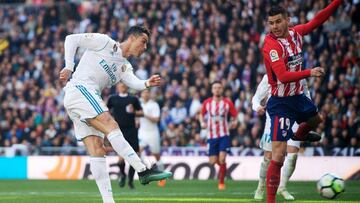 MADRID, SPAIN - APRIL 08: Cristiano Ronaldo of Real Madrid scores his team&#039;s first goal past Lucas Hernandez of Atletico de Madrid during the La Liga match between Real Madrid and Atletico Madrid at Estadio Santiago Bernabeu on April 8, 2018 in Madri