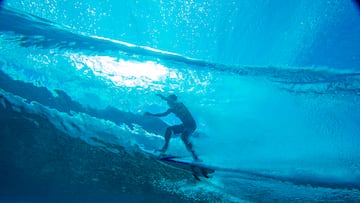 Koa Rothman from Hawaii rides in the "tube", shot from an underwater perspective, at Teahupoo a reef surfing break in Tahiti on August 15, 2019. - The surfers are practicing for the Tahiti pro Trials. (Photo by brian bielmann / AFP) / RESTRICTED TO EDITORIAL USE