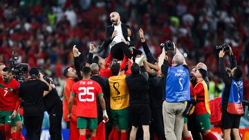 Morocco head coach Walid Regragui and his players celebrate after the match against Portugal at Al Thumama Stadium.