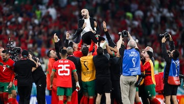 Morocco head coach Walid Regragui and his players celebrate after the match against Portugal at Al Thumama Stadium.