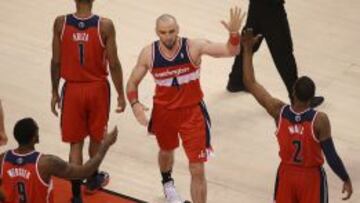 Gortat es felicitado por Wall y Webster con Ariza al fondo.