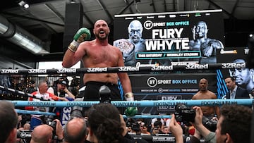 (FILES) In this file photo taken on April 19, 2022 World Boxing Council (WBC) heavyweight title holder Britain's Tyson Fury takes part in an open work-out session in Wembley, west London. - WBC heavyweight champion Tyson Fury said he is retiring from boxing on his 34th birthday on August 12, 2022, having previously performed a number of U-turns over his future in the sport. "After long hard conversations I've finally decided to walk away & on my 34th birthday I say Bon voyage," Fury posted on Twitter. (Photo by JUSTIN TALLIS / AFP)