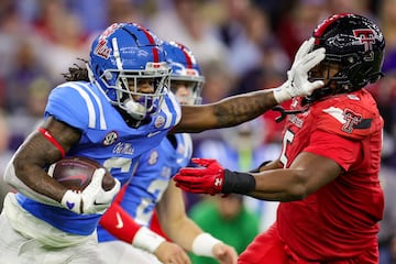 Zach Evans #6 of the Mississippi Rebels pushes off defender Myles Cole #5 of the Texas Tech Red Raiders during the second half at NRG Stadium