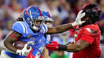 HOUSTON, TEXAS - DECEMBER 28: Zach Evans #6 of the Mississippi Rebels pushes off defender Myles Cole #5 of the Texas Tech Red Raiders during the second half at NRG Stadium on December 28, 2022 in Houston, Texas.   Carmen Mandato/Getty Images/AFP (Photo by Carmen Mandato / GETTY IMAGES NORTH AMERICA / Getty Images via AFP)