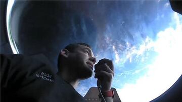 This September 16, 2021, image courtesy of Inspiration4 shows the Inspiration4 crew member Jared Isaacman communicating while looking out of an observation window while in orbit.