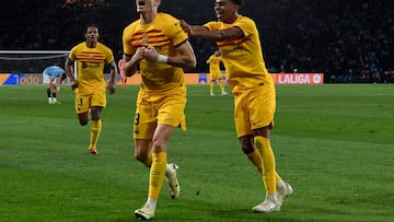 Barcelona's Polish forward #09 Robert Lewandowski celebrates with Barcelona's Spanish forward #27 Lamine Yamal scoring his team's first goal during the Spanish league football match between RC Celta de Vigo and FC Barcelona at the Balaidos stadium in Vigo on February 17, 2024. (Photo by MIGUEL RIOPA / AFP)