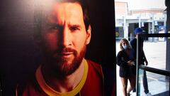 People enter the FC Barcelona museum under the gaze of Lionel Messi, who has informed the club of his intention to leave. 