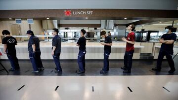 Employees observe social distancing as they order food during their lunch break at the staff canteen while the automaker ramps up car production with new security and health measures as a step to resume full operations, during the outbreak of the coronavi