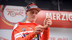 Slovenia&#039;s Matej Mohoric from Team Bahrain-Merida puts on the red jersey of the overall leader after winning the third stage of the Tour of Germany cycling race from Trier to Merzig on August 25, 2018 in Merzig, western Germany. (Photo by Harald Tittel / dpa / AFP) / Germany OUT