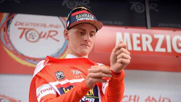 Slovenia's Matej Mohoric from Team Bahrain-Merida puts on the red jersey of the overall leader after winning the third stage of the Tour of Germany cycling race from Trier to Merzig on August 25, 2018 in Merzig, western Germany. (Photo by Harald Tittel / dpa / AFP) / Germany OUT