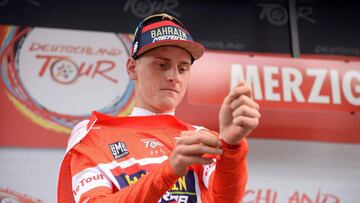 Slovenia&#039;s Matej Mohoric from Team Bahrain-Merida puts on the red jersey of the overall leader after winning the third stage of the Tour of Germany cycling race from Trier to Merzig on August 25, 2018 in Merzig, western Germany. (Photo by Harald Tittel / dpa / AFP) / Germany OUT