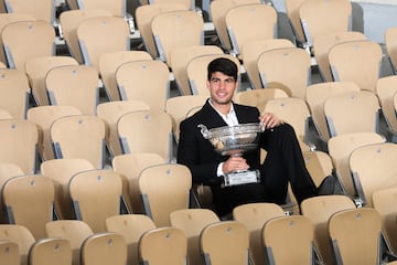 Alcaraz poses with the Coupe des Mousquetaires in the stands at Roland Garros.