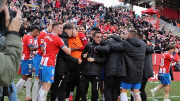 Girona players celebrte their second goal during the Spanish league football match between Girona FC and Valencia CF at the Montilivi stadium in Girona on December 1, 2023. (Photo by LLUIS GENE / AFP)