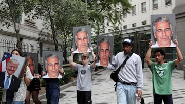 FILE PHOTO: Demonstrators hold signs aloft protesting Jeffrey Epstein, as he awaits arraignment in the Southern District of New York on charges of sex trafficking of minors and conspiracy to commit sex trafficking of minors, in New York, U.S., July 8, 2019. REUTERS/Shannon Stapleton/File Photo