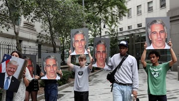 FILE PHOTO: Demonstrators hold signs aloft protesting Jeffrey Epstein, as he awaits arraignment in the Southern District of New York on charges of sex trafficking of minors and conspiracy to commit sex trafficking of minors, in New York, U.S., July 8, 2019. REUTERS/Shannon Stapleton/File Photo