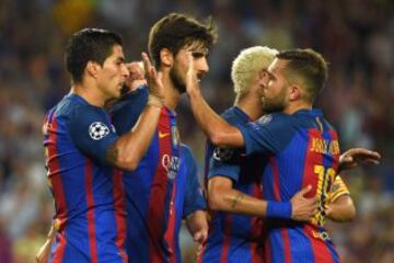 Barcelona's Uruguayan forward Luis Suarez (L) celebrates a goal with Barcelona's defender Jordi Alba (R)and Barcelona's Portuguesse midfielder Andre Gomes (C) during the UEFA Champions League football match FC Barcelona vs Celtic FC at the Camp Nou stadiu