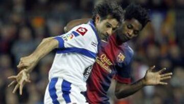 El centrocampista del Deportivo de La Coruña Juan Carlos Valerón (i) controla el balón ante el centrocampista camerunés del Fútbol Club Barcelona Alexandre Song.