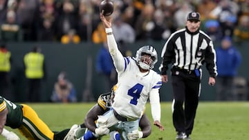 GREEN BAY, WISCONSIN - NOVEMBER 13: Dak Prescott #4 of the Dallas Cowboys attempts a pass while being tackled by Jarran Reed #90 of the Green Bay Packers during overtime at Lambeau Field on November 13, 2022 in Green Bay, Wisconsin.   Patrick McDermott/Getty Images/AFP