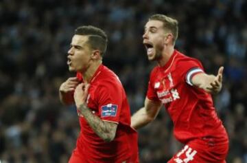Coutinho and Jordan Henderson run towards the travelling Liverpool supporters.
