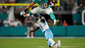 Dec 11, 2023; Miami Gardens, Florida, USA; Miami Dolphins fullback Alec Ingold (30) leaps over Tennessee Titans cornerback Roger McCreary (21) during the second half at Hard Rock Stadium. Mandatory Credit: Jasen Vinlove-USA TODAY Sports TPX IMAGES OF THE DAY