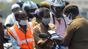 Police check a commuter for credentials in Chennai on April 1, 2020. 